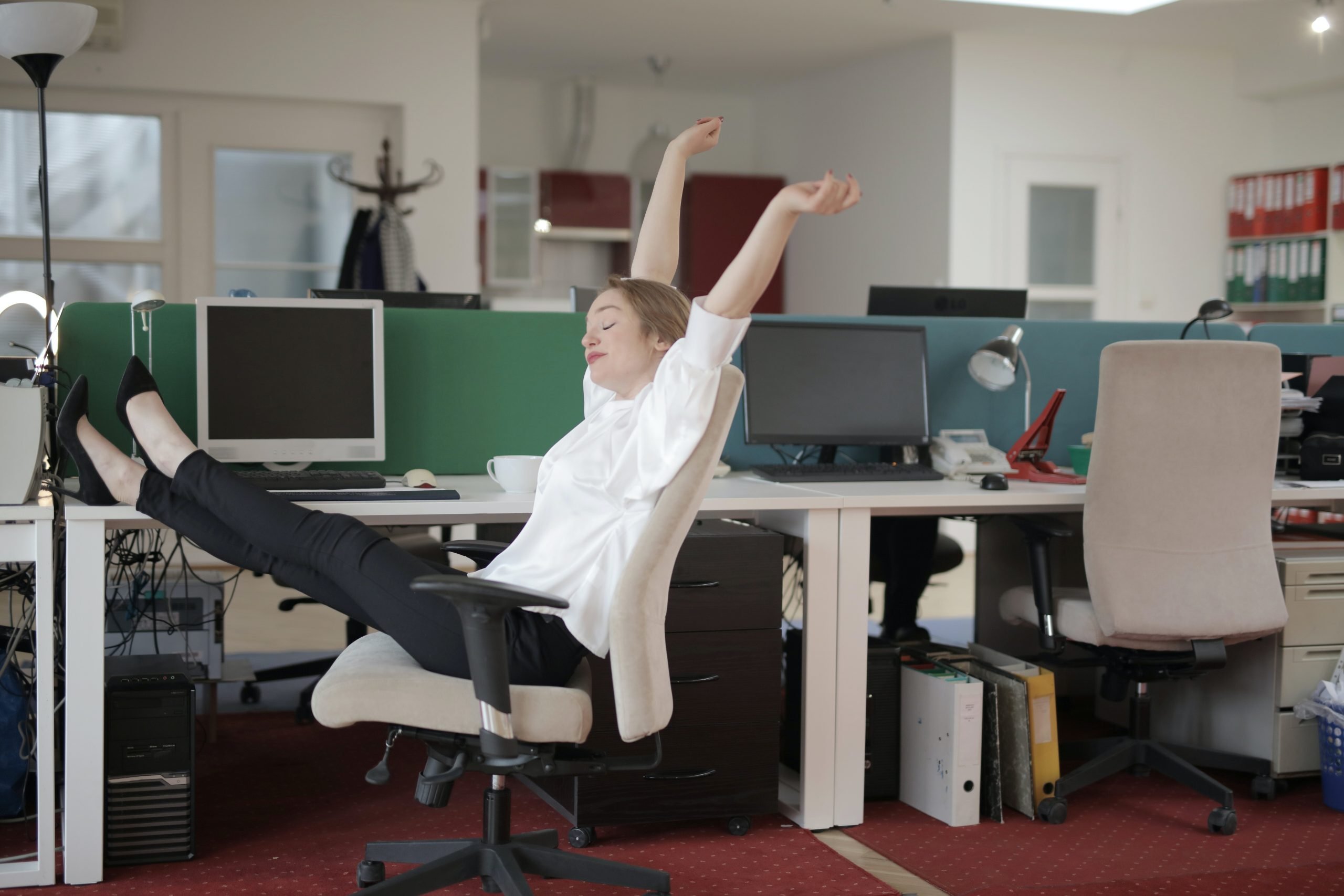 woman leaning back on her office chair procrastinating