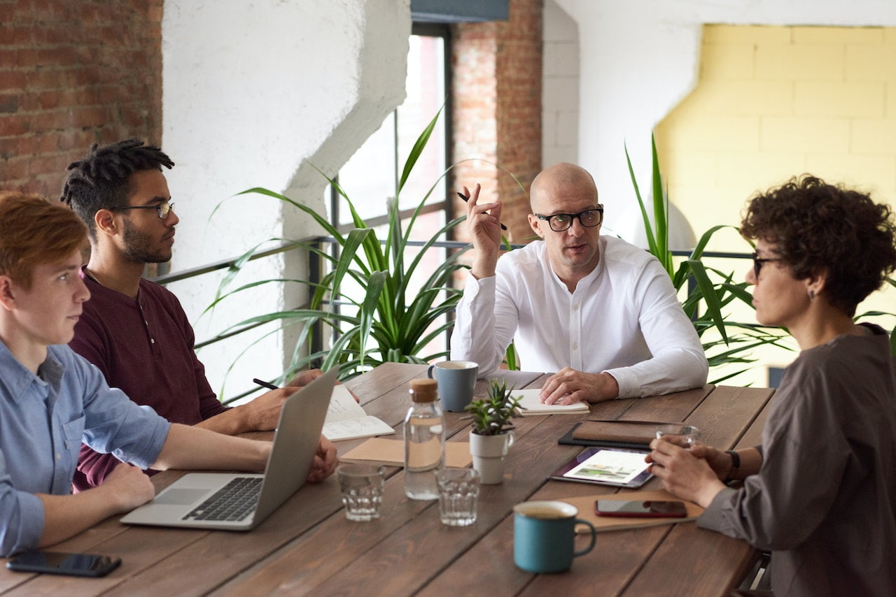 group of team members at a table having a meeting